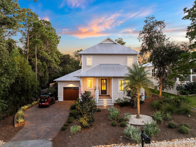 view of front of property with covered porch and a garage