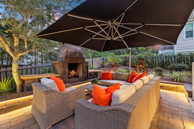 view of patio featuring an outdoor living space with a fireplace