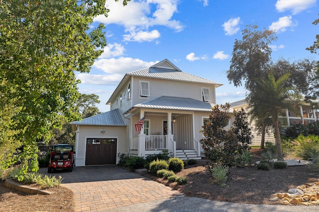 view of front facade featuring a porch and a garage