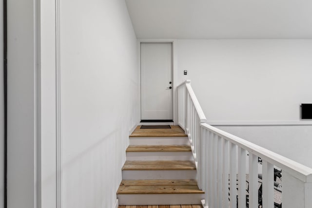 stairs featuring hardwood / wood-style floors