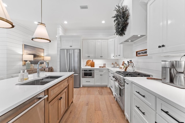 kitchen featuring white cabinets, appliances with stainless steel finishes, and sink