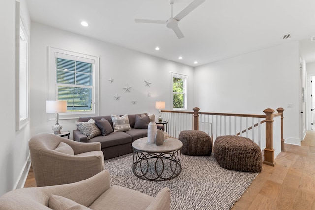 living room with ceiling fan and light hardwood / wood-style floors