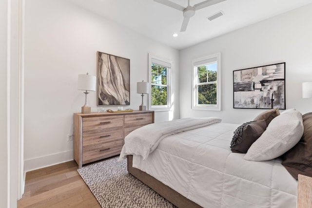 bedroom with ceiling fan and light hardwood / wood-style floors