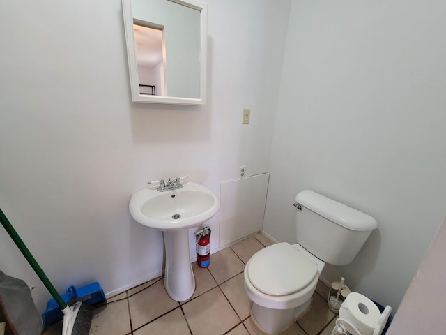 half bathroom featuring toilet and tile patterned floors