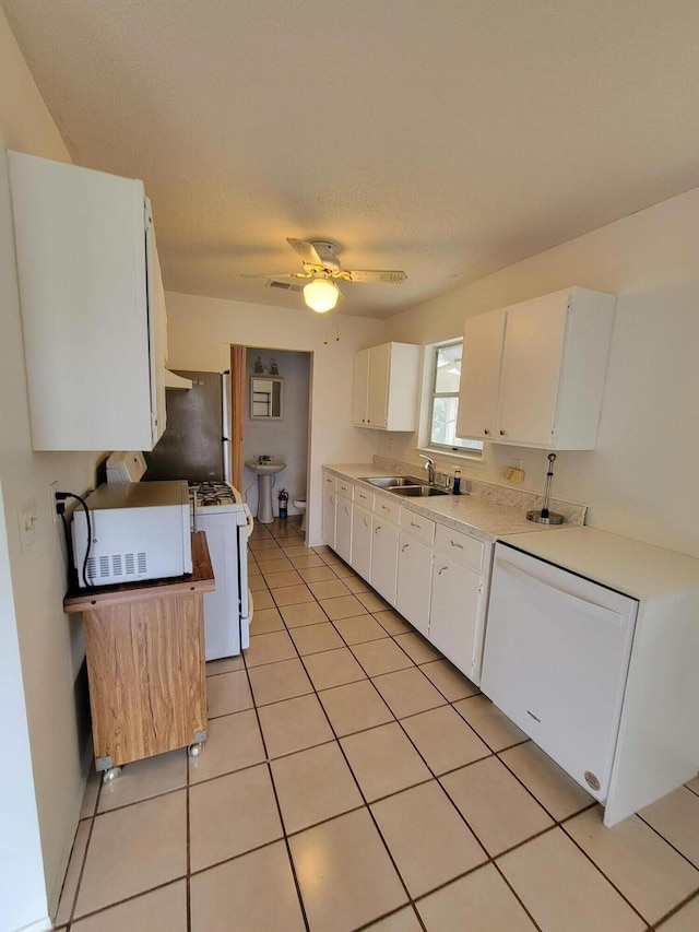 kitchen with ceiling fan, sink, white cabinets, and white appliances