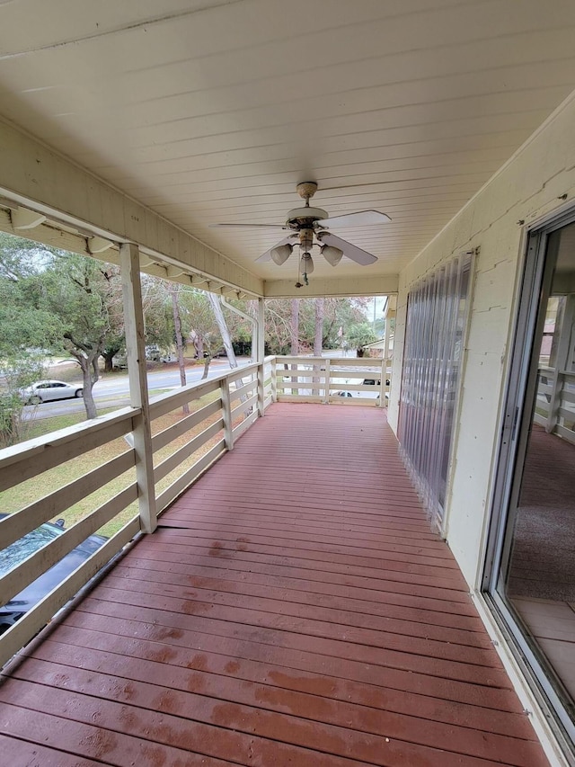 wooden deck with a ceiling fan