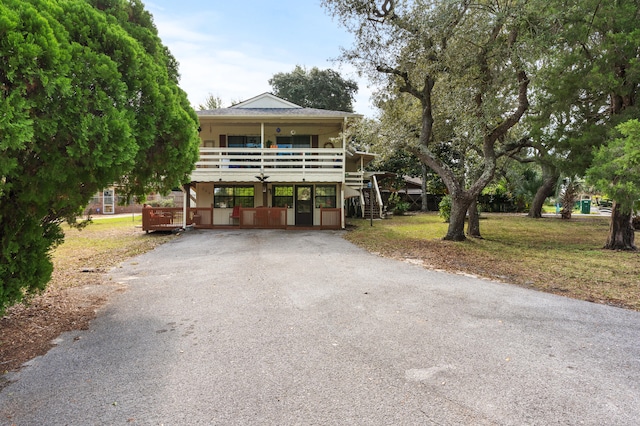 view of front of home featuring a balcony and a front yard