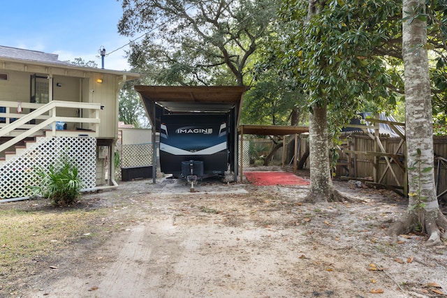 exterior space with fence and a detached carport