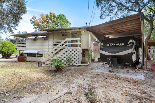 back of property featuring a carport