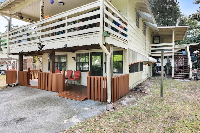 view of property exterior with a wooden deck