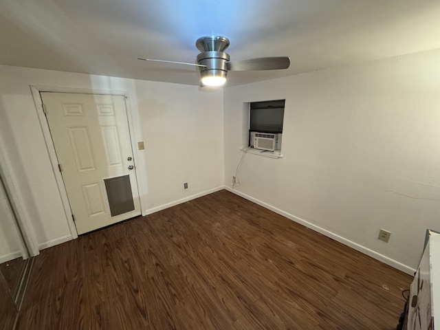 spare room with dark wood-type flooring and ceiling fan