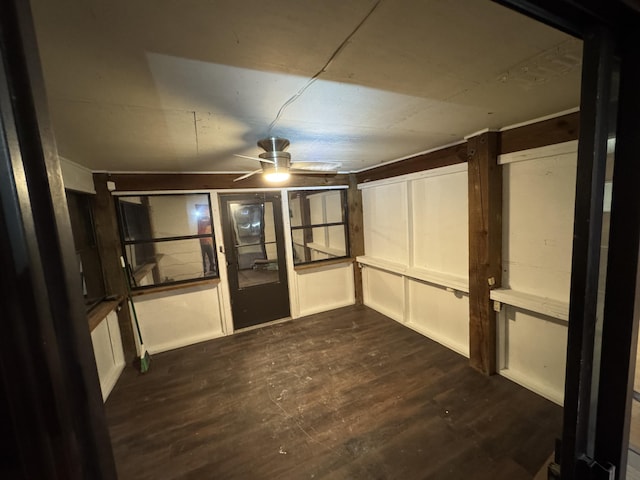 basement featuring dark hardwood / wood-style floors and ceiling fan