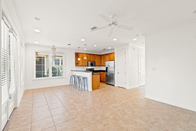 kitchen with pendant lighting, appliances with stainless steel finishes, a breakfast bar, and crown molding