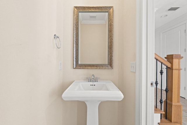 bathroom featuring ornamental molding