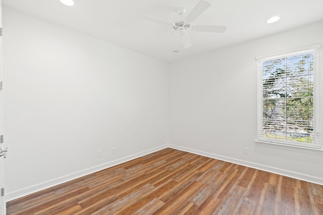 unfurnished room with hardwood / wood-style flooring and ceiling fan