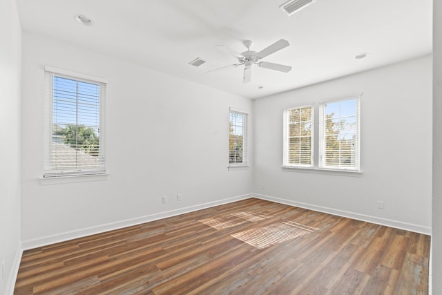 unfurnished room with dark hardwood / wood-style floors and ceiling fan