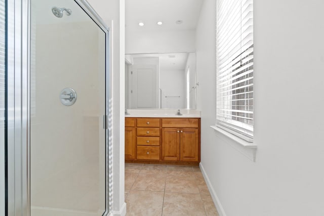 bathroom with tile patterned flooring, vanity, and a shower with shower door