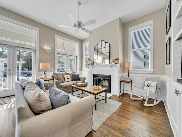 living room with french doors, ceiling fan, dark hardwood / wood-style flooring, and a tile fireplace