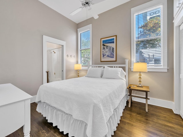 bedroom with multiple windows, dark hardwood / wood-style floors, and ceiling fan