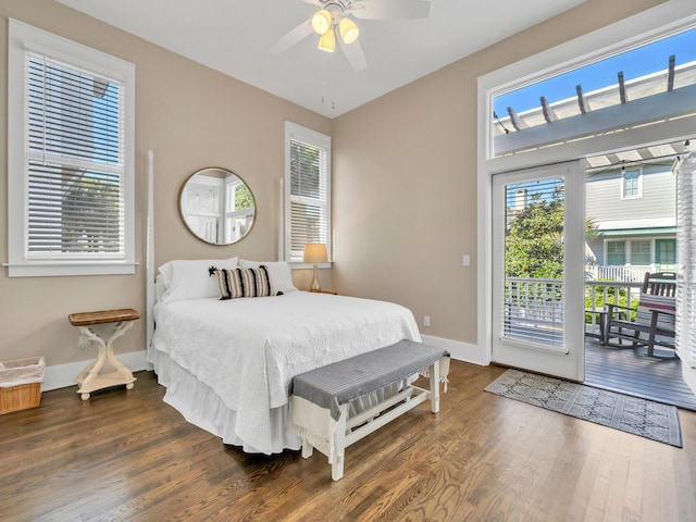 bedroom featuring access to outside, dark hardwood / wood-style floors, and ceiling fan