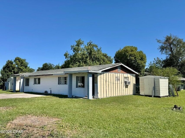 260 Seneca Ave, Panama City, FL 32404 - view of front of house with a front yard, a storage unit, and cooling unit