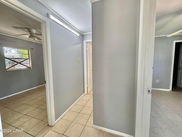 260 Seneca Ave, Panama City, FL 32404 - hall with light tile patterned flooring, ornamental molding, a textured ceiling, and baseboards