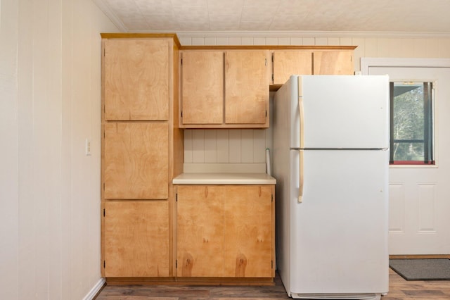 kitchen with ornamental molding, white refrigerator, light brown cabinets, and dark wood-type flooring