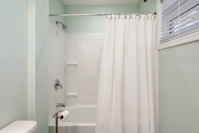 bathroom with toilet and shower / bath combination with curtain