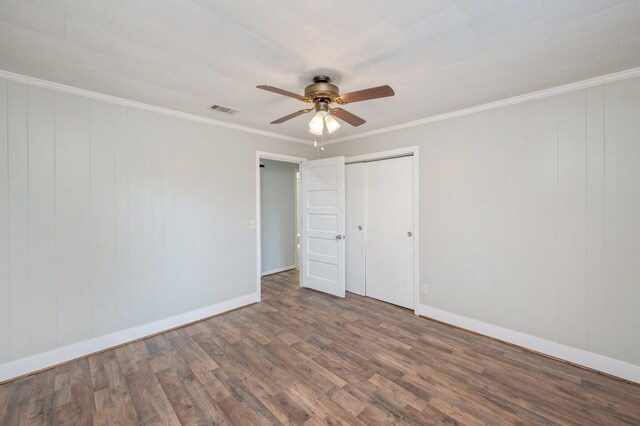 18040 US Highway 331 N, Defuniak Springs, FL 32433 - unfurnished bedroom with wood finished floors, baseboards, ornamental molding, a ceiling fan, and a closet