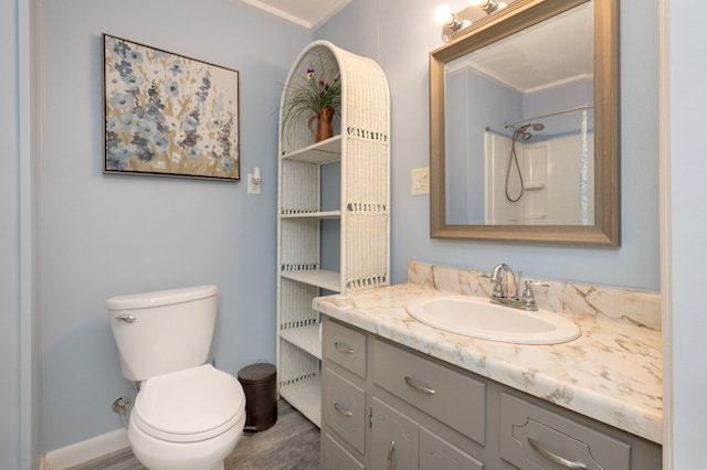 bathroom with vanity, toilet, a shower, crown molding, and hardwood / wood-style floors