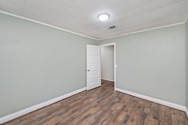 empty room with dark wood-type flooring and crown molding