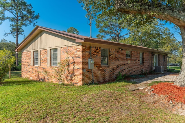 view of property exterior featuring cooling unit and a lawn