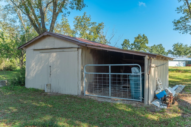 view of outbuilding featuring a yard