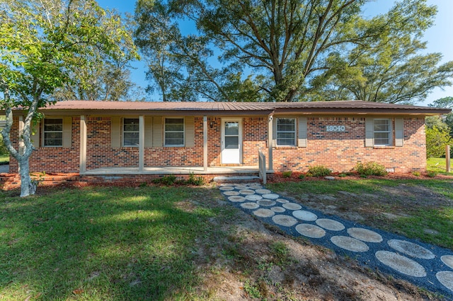 ranch-style home with a front yard and a porch