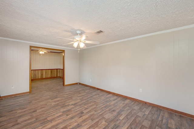 empty room with ceiling fan, crown molding, dark hardwood / wood-style flooring, and a textured ceiling