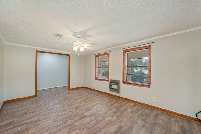 18040 US Highway 331 N, Defuniak Springs, FL 32433 - empty room with heating unit, wood finished floors, a ceiling fan, a textured ceiling, and crown molding