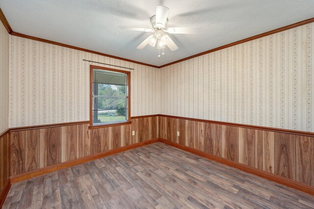 18040 US Highway 331 N, Defuniak Springs, FL 32433 - empty room with crown molding, wood finished floors, ceiling fan, a textured ceiling, and wood walls