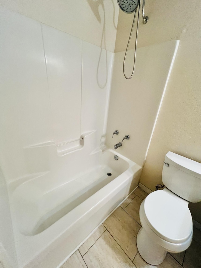 bathroom featuring bathtub / shower combination and toilet