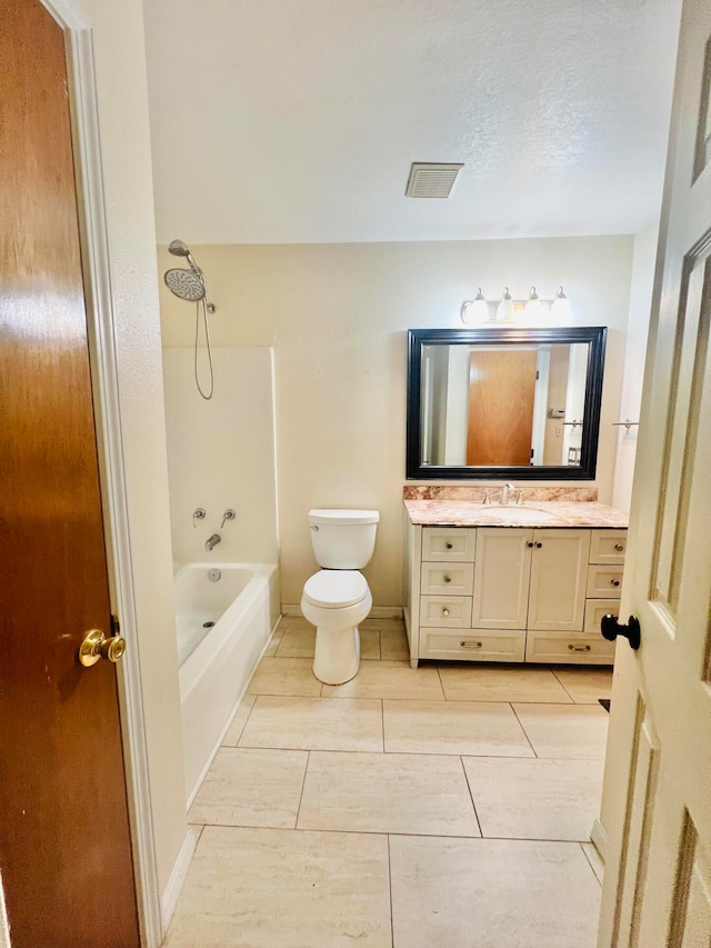 full bathroom featuring vanity, toilet, a textured ceiling, and shower / washtub combination