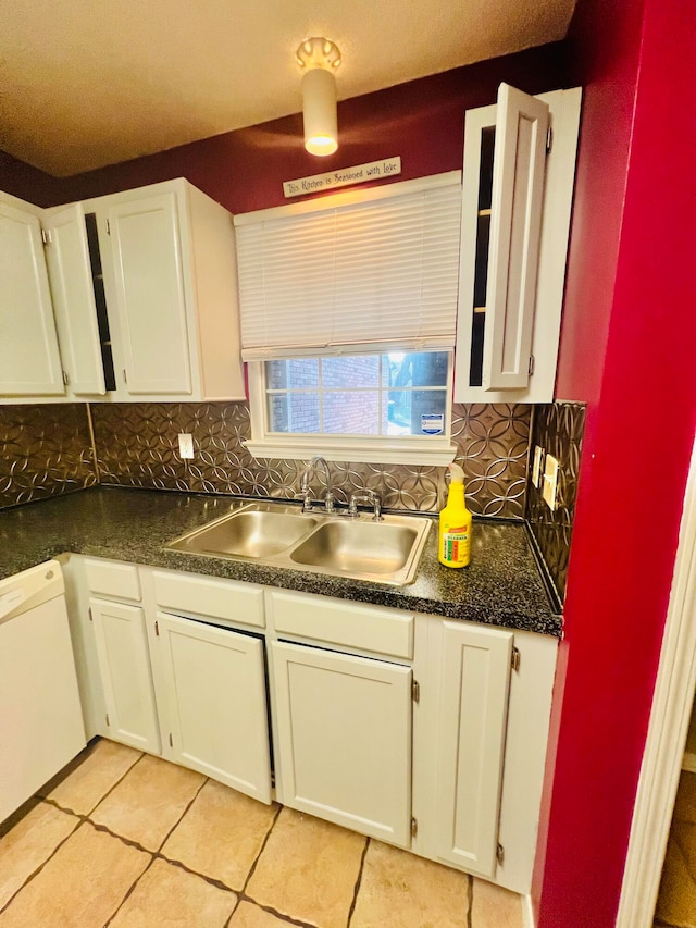 kitchen with white cabinetry, decorative backsplash, and sink