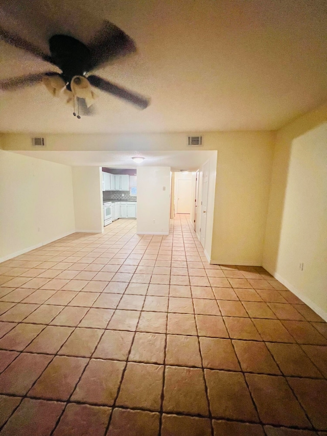 unfurnished room with light tile patterned flooring and ceiling fan