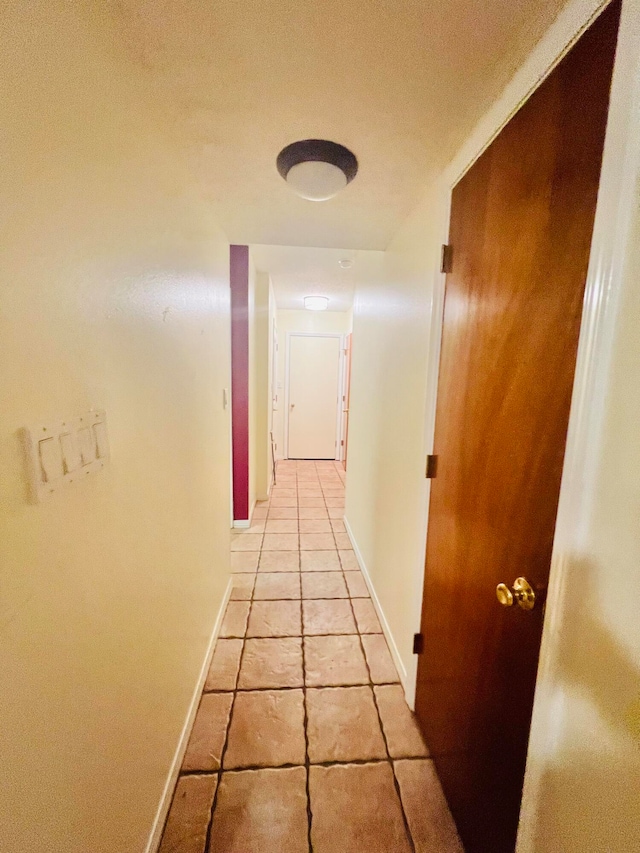 corridor featuring light tile patterned floors