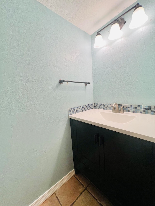 bathroom featuring vanity, a textured ceiling, and tile patterned flooring