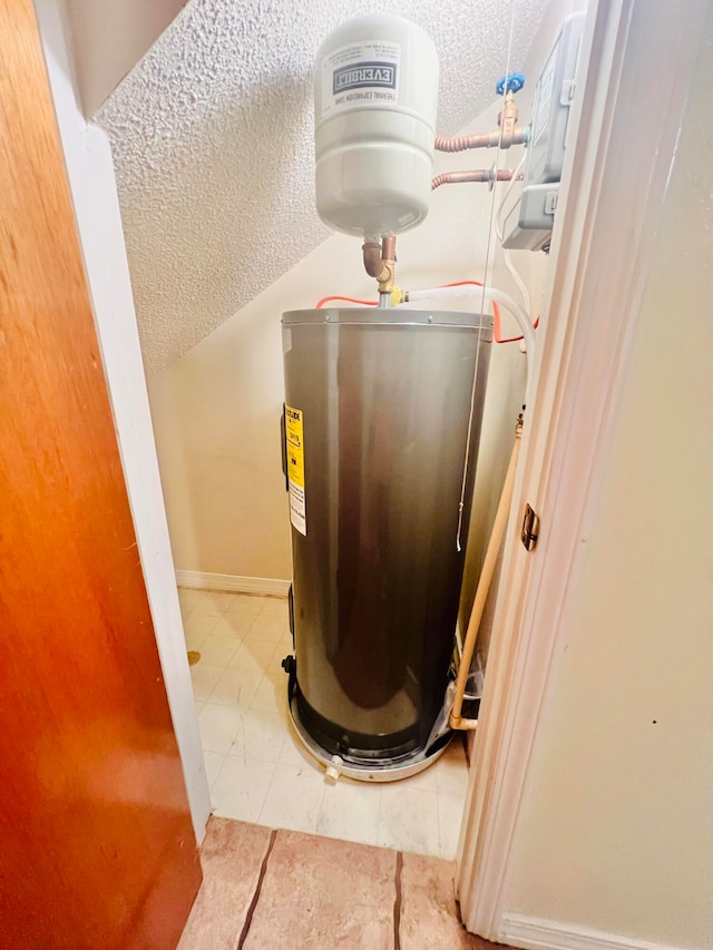 utility room featuring water heater