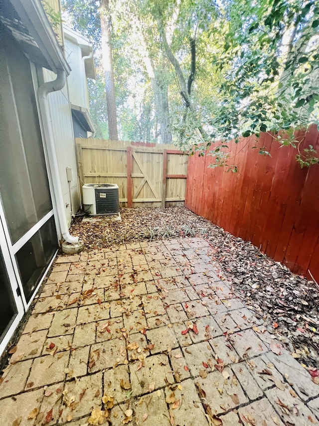 view of patio / terrace with a fenced backyard and central air condition unit
