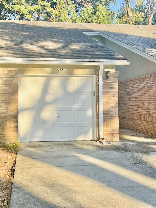 garage with concrete driveway