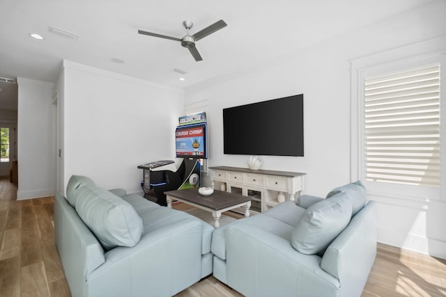 living room with light wood-type flooring, ceiling fan, baseboards, and recessed lighting