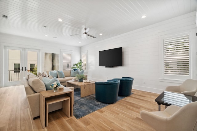 living room featuring ceiling fan, french doors, light hardwood / wood-style floors, and wooden ceiling