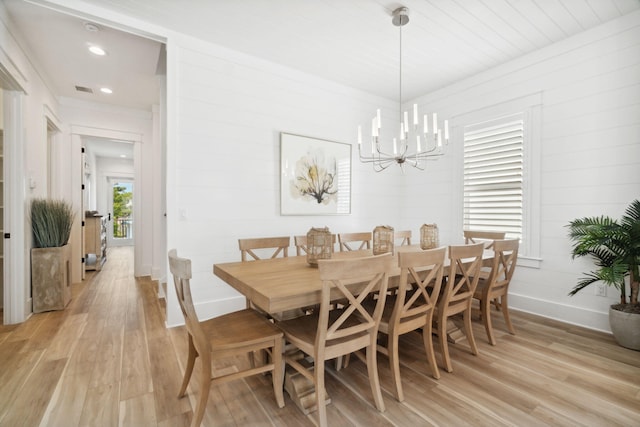 dining area featuring a notable chandelier and light hardwood / wood-style floors