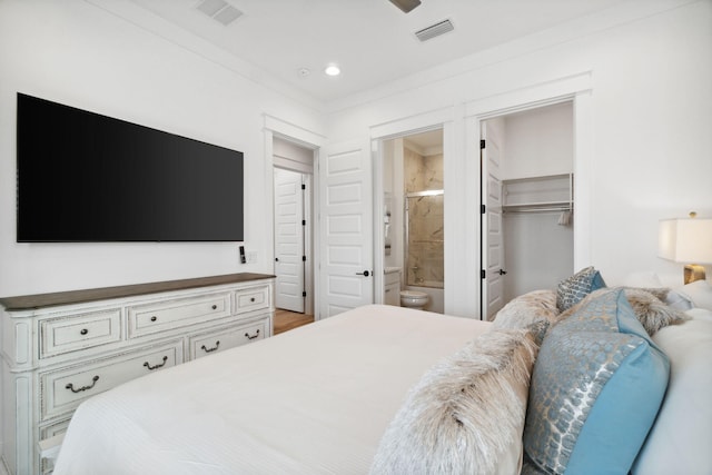 bedroom featuring recessed lighting, a spacious closet, visible vents, and ensuite bathroom